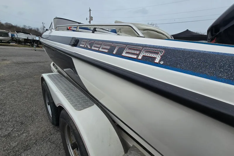 Slide: The Image of 2001 Skeeter SL 190 boat on trailer, side view with logo visible. - 16