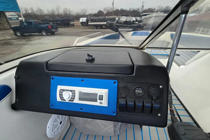 Slide: The Image of 2001 Skeeter SL 190 boat dashboard with control panel and stereo system. - 4