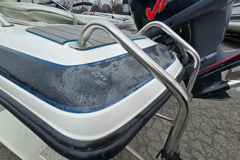 Slide: The Image of 2001 Skeeter SL 190 boat with stainless steel railings and weathered surface. - 5