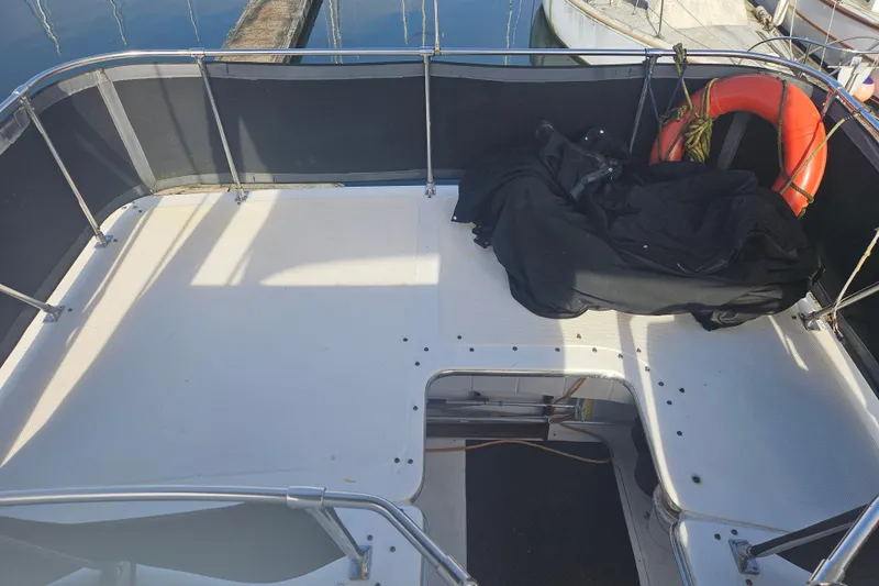 Slide: The Image of 1994 Bayliner 3288 Motoryacht deck with railing, life preserver, and black cover. - 10