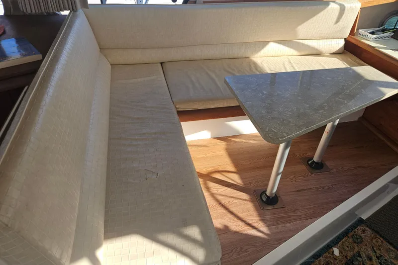 Slide: The Image of 1994 Bayliner 3288 Motoryacht interior with beige seating and a marble table. - 14