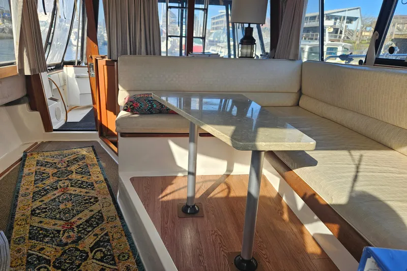 Slide: The Image of 1994 Bayliner 3288 Motoryacht interior with seating, table, and decorative rug. - 16