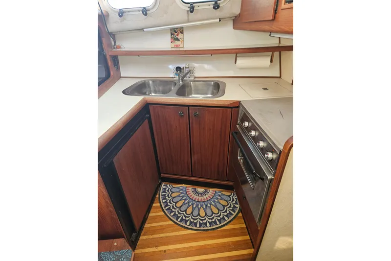 Slide: The Image of 1994 Bayliner 3288 Motoryacht kitchen with wood cabinets, double sink, and stove. - 17