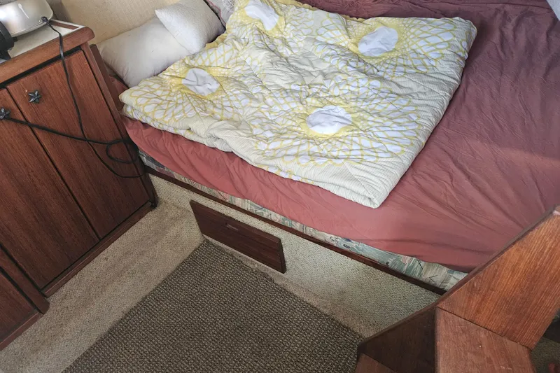 Slide: The Image of Cozy cabin interior of 1994 Bayliner 3288 Motoryacht with bed and wooden cabinetry. - 20