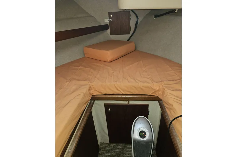 Slide: The Image of 1994 Bayliner 3288 Motoryacht cabin interior with orange bedding and a portable heater. - 22