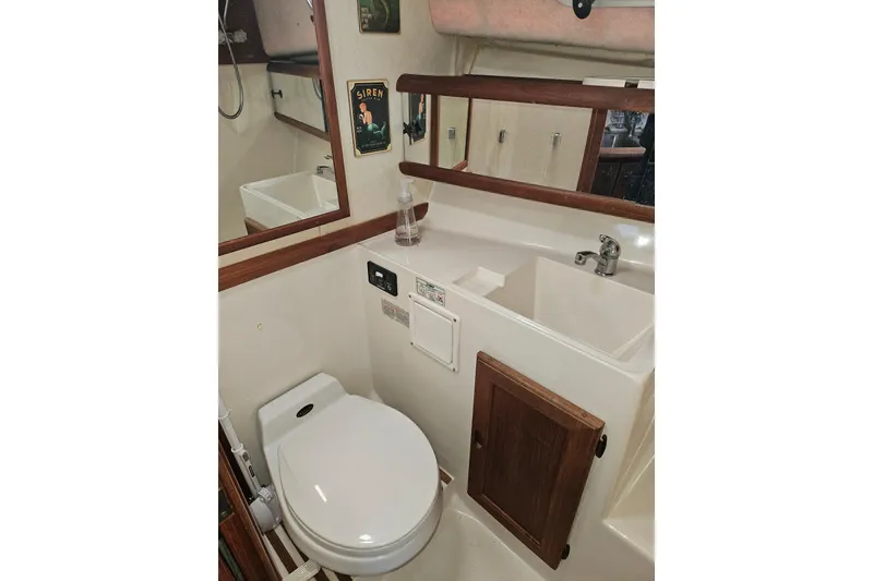 Slide: The Image of 1994 Bayliner 3288 Motoryacht bathroom with toilet, sink, and mirror. - 23