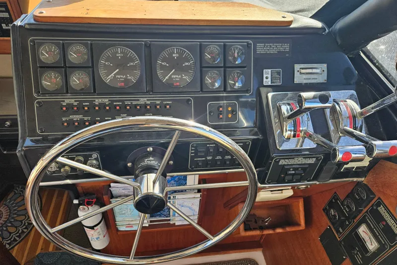 Slide: The Image of 1994 Bayliner 3288 Motoryacht helm with steering wheel, gauges, and control panel. - 27