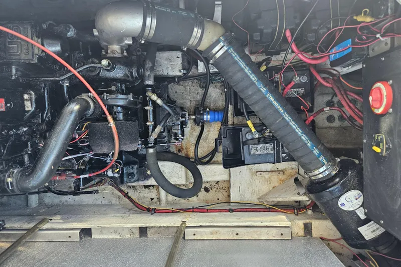 Slide: The Image of Engine compartment of a 1994 Bayliner 3288 Motoryacht with visible wiring and components. - 33
