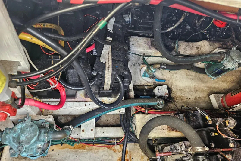 Slide: The Image of Engine compartment of 1994 Bayliner 3288 Motoryacht with visible wiring and hoses. - 34