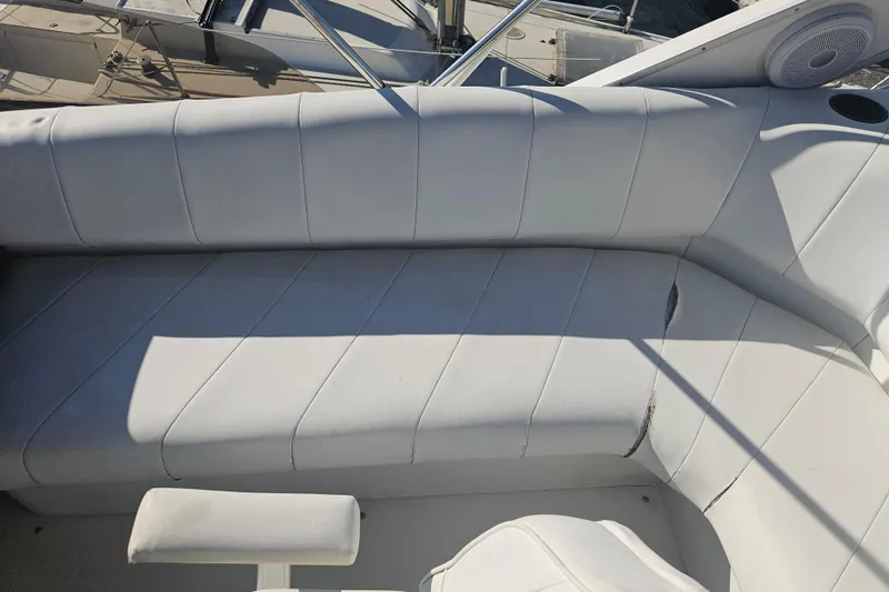 Slide: The Image of White seating area on a 1994 Bayliner 3288 Motoryacht, featuring a curved design. - 9