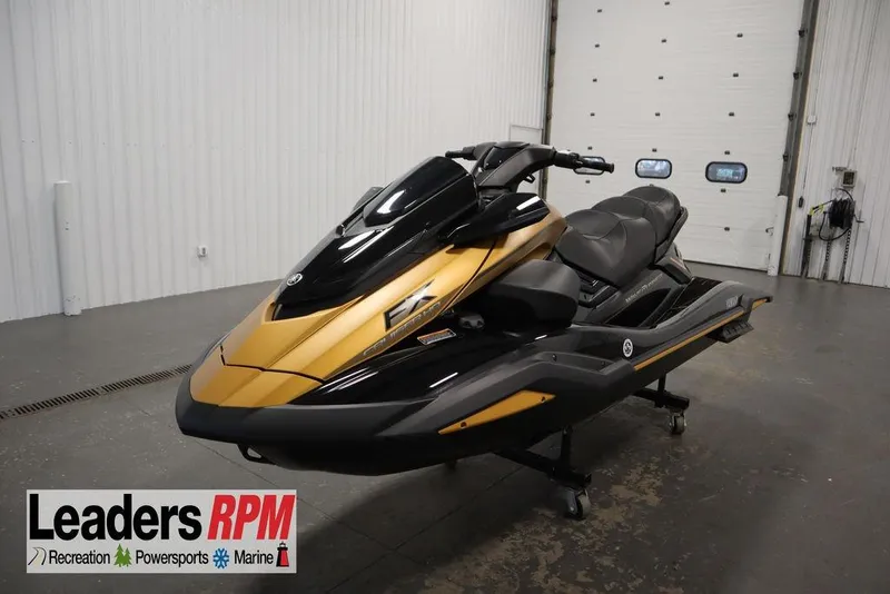 The Image of 2025 Yamaha WaveRunner FX Cruiser HO in showroom, featuring sleek black and gold design. - 1
