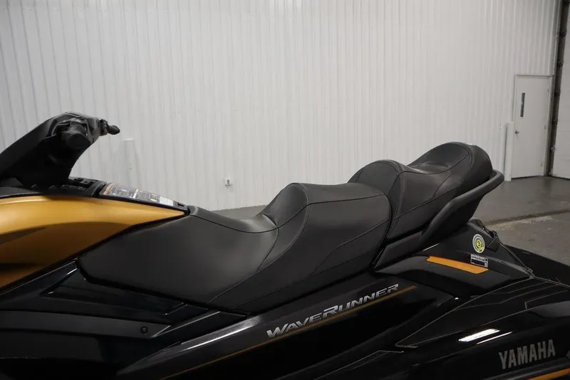 Slide: The Image of 2025 Yamaha WaveRunner FX Cruiser HO with sleek black and gold design in a showroom. - 22