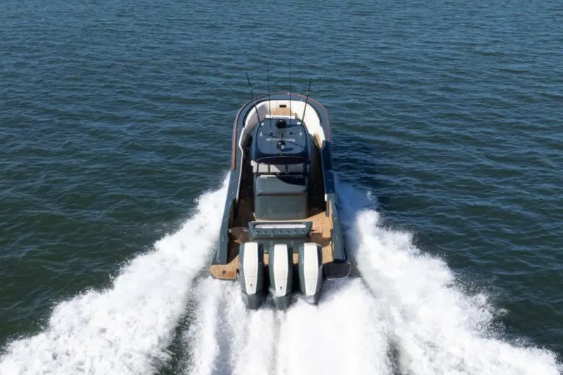 Slide: The Image of 2026 Buddy Davis Pininfarina boat cruising on open water, rear view. - 3