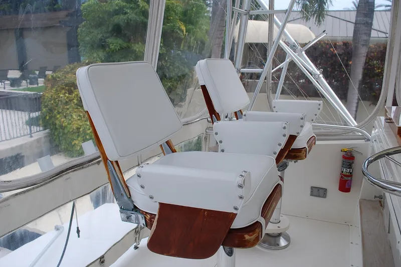 Slide: The Image of Interior of 1988 Viking 45 Convertible yacht with white captain chairs and a fire extinguisher. - 11