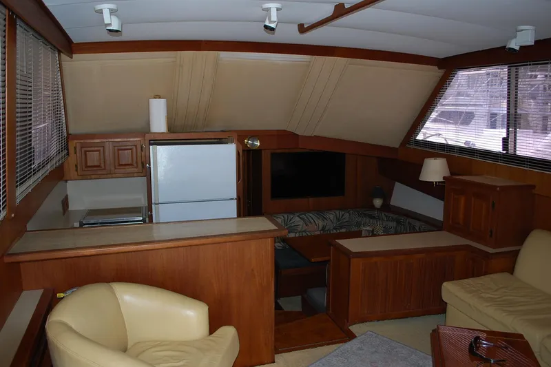 Slide: The Image of Interior of 1988 Viking 45 Convertible yacht with wood paneling and modern amenities. - 12