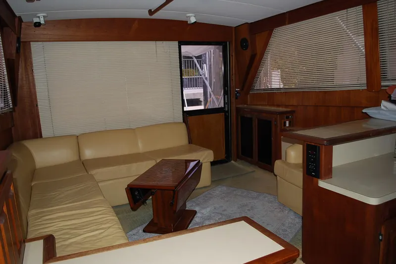 Slide: The Image of 1988 Viking 45 Convertible yacht interior with beige seating and wooden accents. - 13