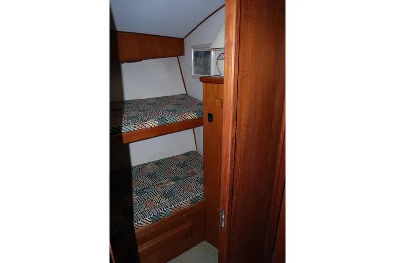 Slide: The Image of Cozy bedroom in 1988 Viking 45 Convertible yacht with wooden cabinetry and skylight. - 19