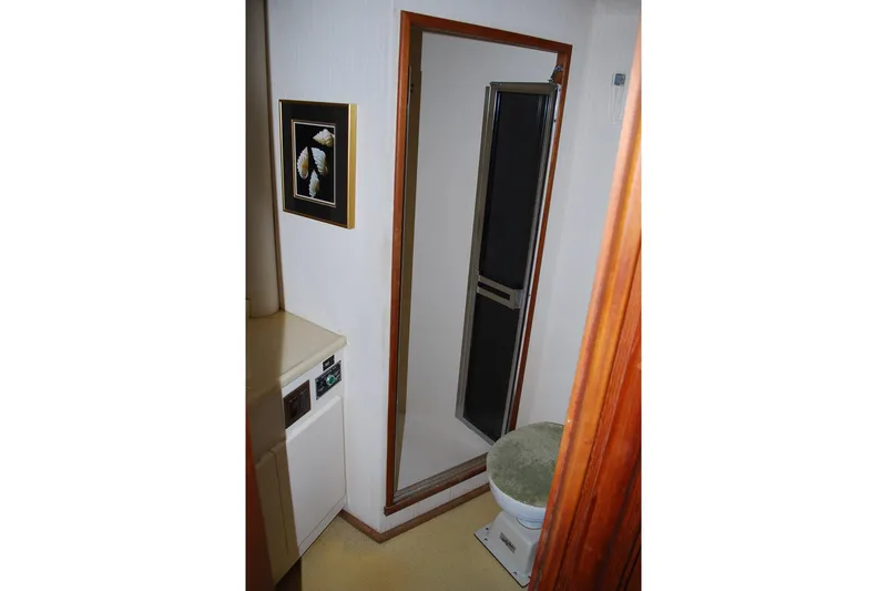 Slide: The Image of 1988 Viking 45 Convertible yacht bathroom with sink, shower, and framed artwork. - 20