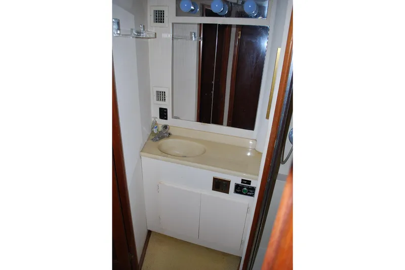Slide: The Image of 1988 Viking 45 Convertible cabin with wooden bunk beds and patterned cushions. - 21