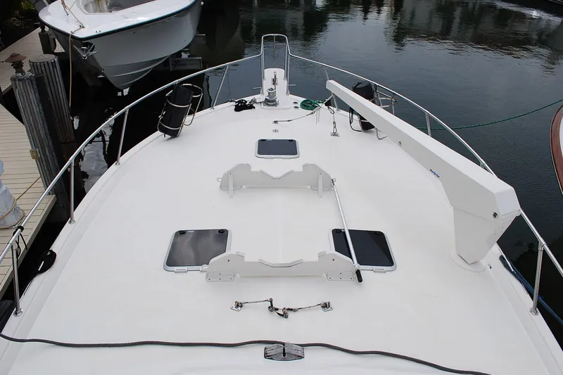 Slide: The Image of 1988 Viking 45 Convertible yacht deck with hatches and equipment, docked in marina. - 3