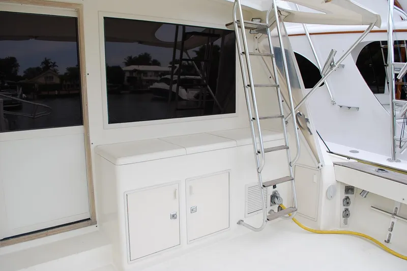 Slide: The Image of 1988 Viking 45 Convertible yacht deck with ladder and storage compartments. - 4