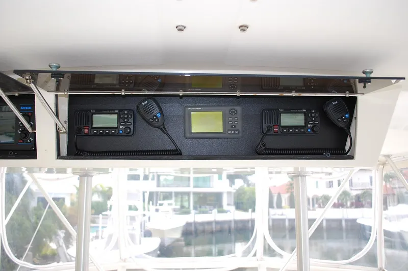 Slide: The Image of 1988 Viking 45 Convertible boat dashboard with communication equipment and navigation controls. - 8