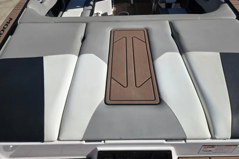 Slide: The Image of 2020 Moomba Helix boat interior with cushioned seating and wooden panel detail. - 12