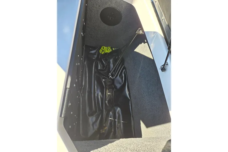 Slide: The Image of 2020 Moomba Helix boat storage compartment with black interior and equipment. - 27