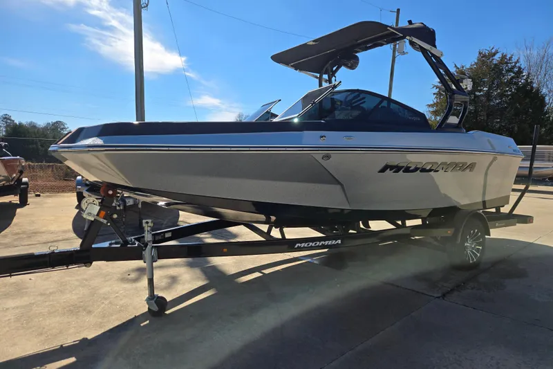 Slide: The Image of 2020 Moomba Helix boat on trailer, parked outdoors under clear blue sky. - 3