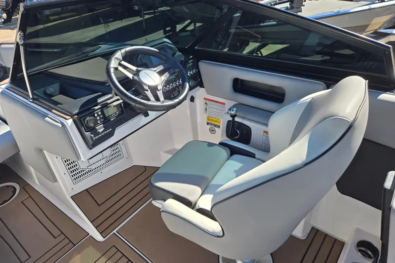 Slide: The Image of 2020 Moomba Helix boat interior with steering wheel and captain's chair. - 31