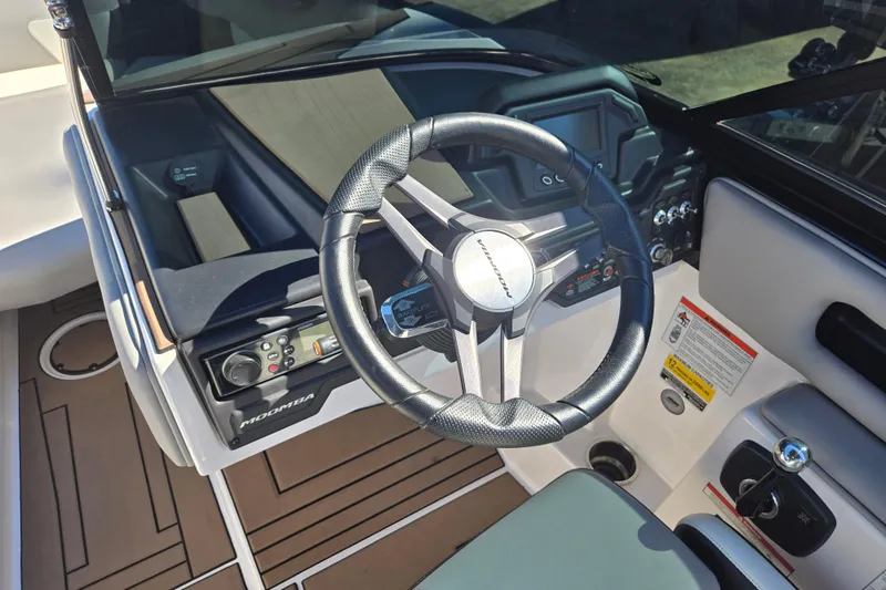 Slide: The Image of 2020 Moomba Helix boat dashboard with steering wheel and control panel. - 38
