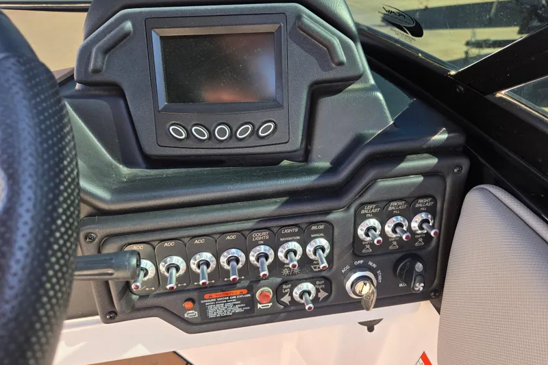 Slide: The Image of Control panel of a 2020 Moomba Helix boat with switches and display screen. - 39