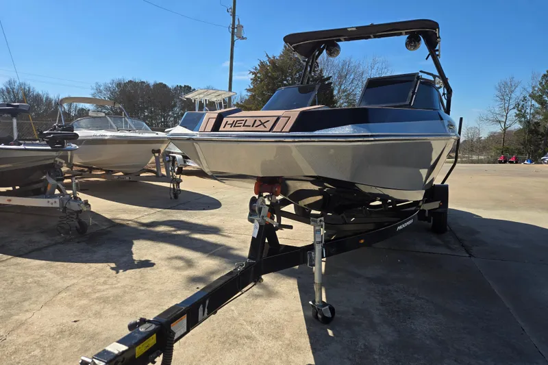 Slide: The Image of 2020 Moomba Helix boat on trailer in sunny outdoor setting. - 5