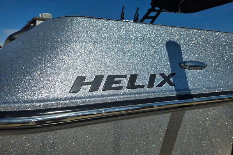Slide: The Image of 2020 Moomba Helix boat with sparkling silver finish under clear blue sky. - 6
