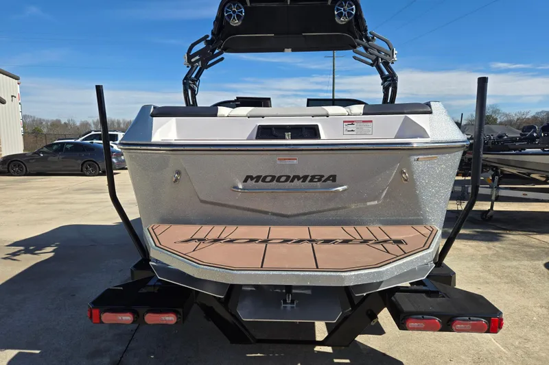 Slide: The Image of 2020 Moomba Helix boat rear view with swim platform and tower, parked outdoors. - 9