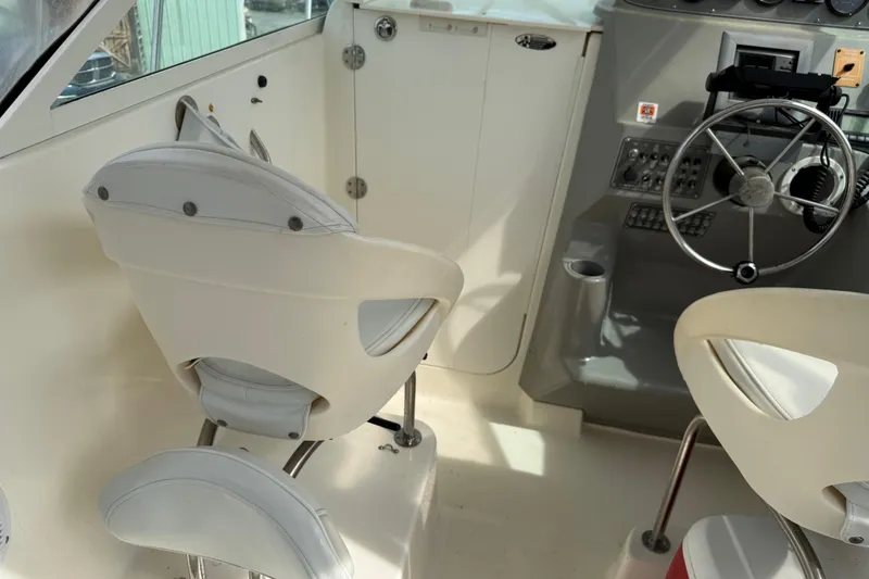 Slide: The Image of Interior of a 2006 Trophy 2502 Walkaround boat with steering wheel and seating. - 10