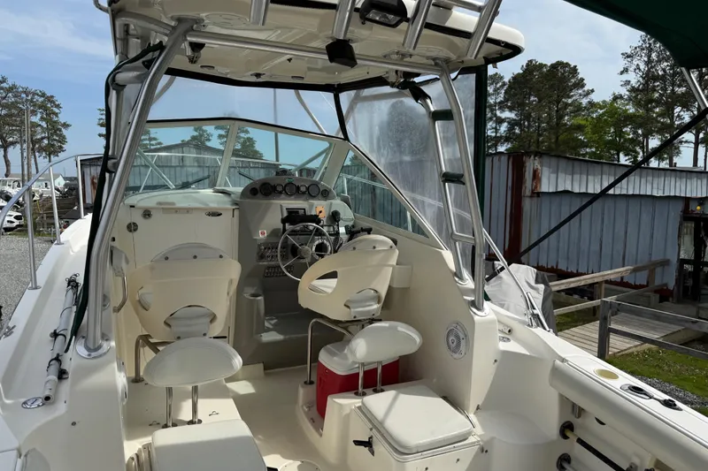 Slide: The Image of 2006 Trophy 2502 Walkaround boat interior with steering wheel and seating. - 12