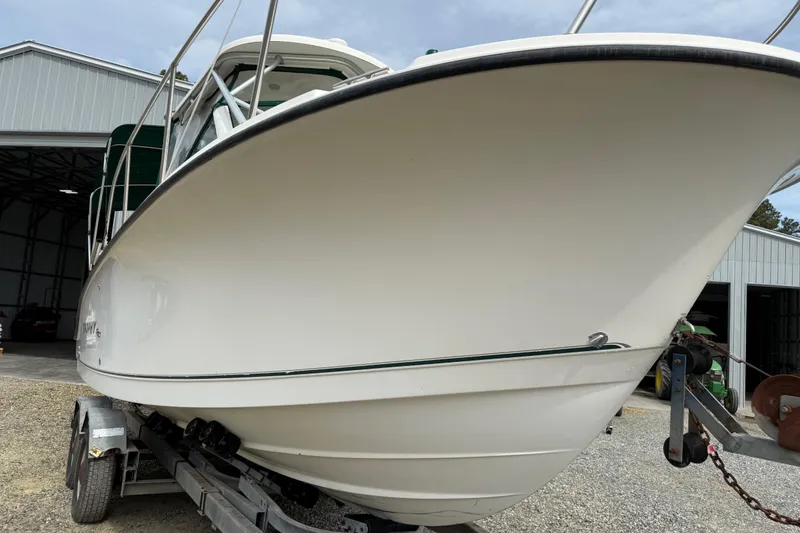 Slide: The Image of 2006 Trophy 2502 Walkaround boat on trailer outside a metal building. - 13