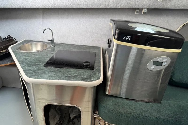 Slide: The Image of 2006 Trophy 2502 Walkaround boat interior with sink, countertop, and SPT appliance. - 21