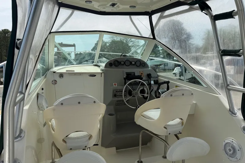 Slide: The Image of 2006 Trophy 2502 Walkaround boat interior with steering wheel and seating. - 29