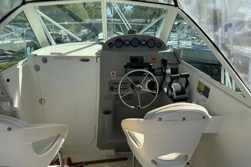 Slide: The Image of Interior cockpit of a 2006 Trophy 2502 Walkaround boat with steering wheel and controls. - 6