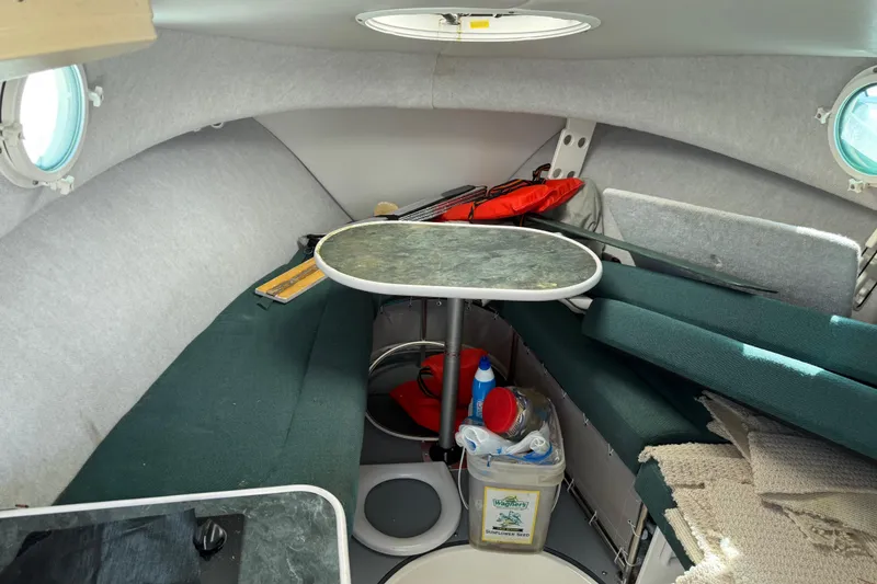 Slide: The Image of Interior of a 2006 Trophy 2502 Walkaround boat with seating and table. - 7