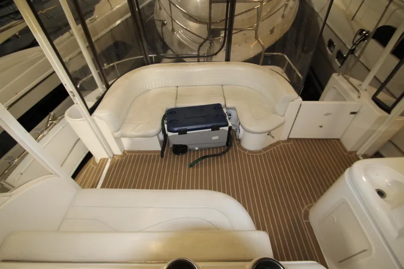 Slide: The Image of 2003 Cruisers Yachts 4450 Express Motoryacht interior with white seating and wood flooring. - 13