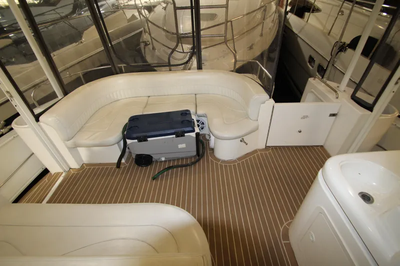 Slide: The Image of 2003 Cruisers Yachts 4450 Express Motoryacht interior with seating and cooler on deck. - 14