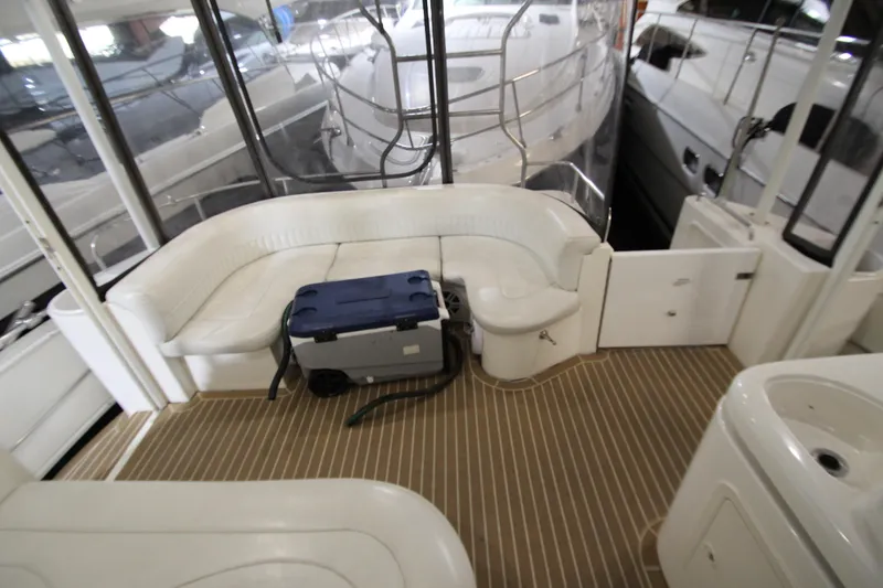 Slide: The Image of 2003 Cruisers Yachts 4450 Express Motoryacht interior with white seating and wooden flooring. - 15