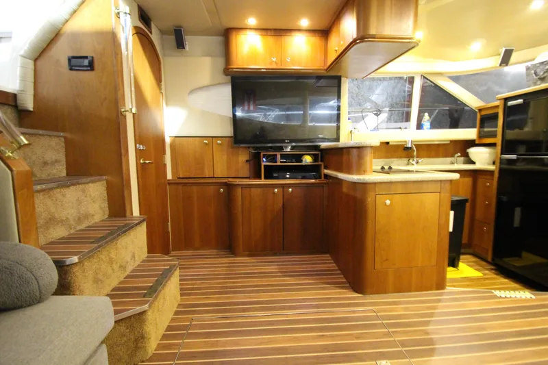 Slide: The Image of Luxurious interior of 2003 Cruisers Yachts 4450 Express Motoryacht with wood cabinetry and modern amenities. - 28
