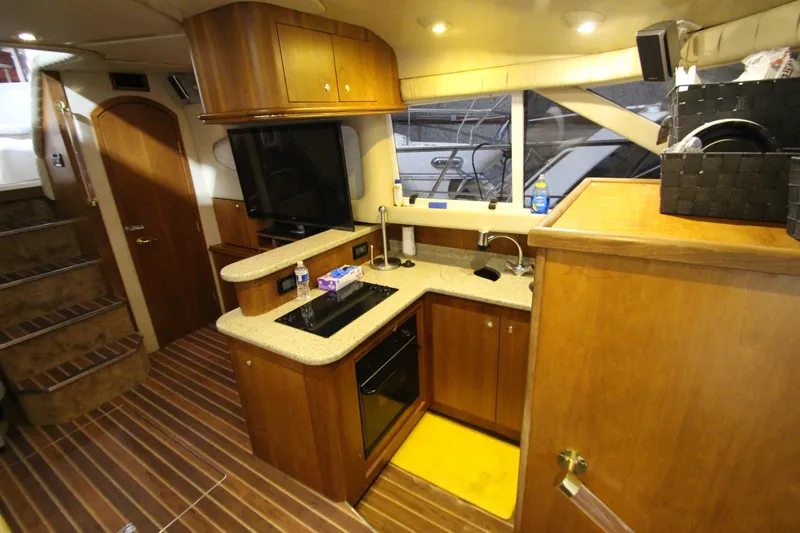 Slide: The Image of Luxurious 2003 Cruisers Yachts 4450 Express Motoryacht interior with modern kitchen amenities. - 38