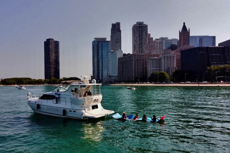 Slide: The Image of 2003 Cruisers Yachts 4450 near city skyline on the water. - 5