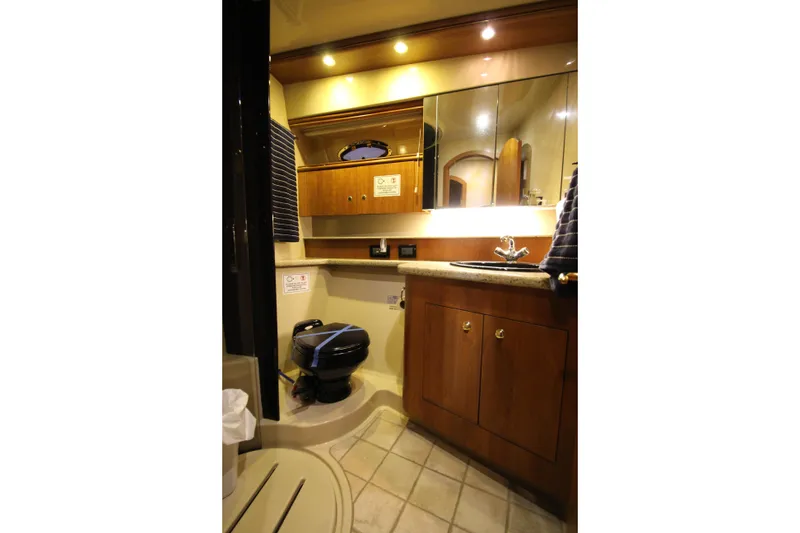 Slide: The Image of Luxurious bathroom in 2003 Cruisers Yachts 4450 Express Motoryacht with wood cabinetry. - 52