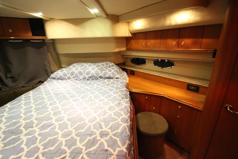 Slide: The Image of Luxurious 2003 Cruisers Yachts 4450 Express Motoryacht bedroom with elegant wood cabinetry. - 60
